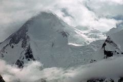 
The next morning we started our trek from Shagring Camp to Gasherbrum Base Camp in mostly cloudy weather. After 30 minutes we reached �Gasherbrum Corner� at the junction of the Upper Baltoro Glacier with the tributary Abruzzi Glacier. Gasherbrum I and Gasherbrum I South lie straight ahead. Gasherbrum I (8080m) is the 11th highest mountain in the world. Gasherbrum I was first climbed by July 5, 1958 by Americans Pete Schoening and Andy Kauffman. Gasherbrum I South (7069m) was first climbed by Maurice Barrard and Georges Narbaud via the Southwest Ridge in July 1980 on their ascent of Gasherbrum I
